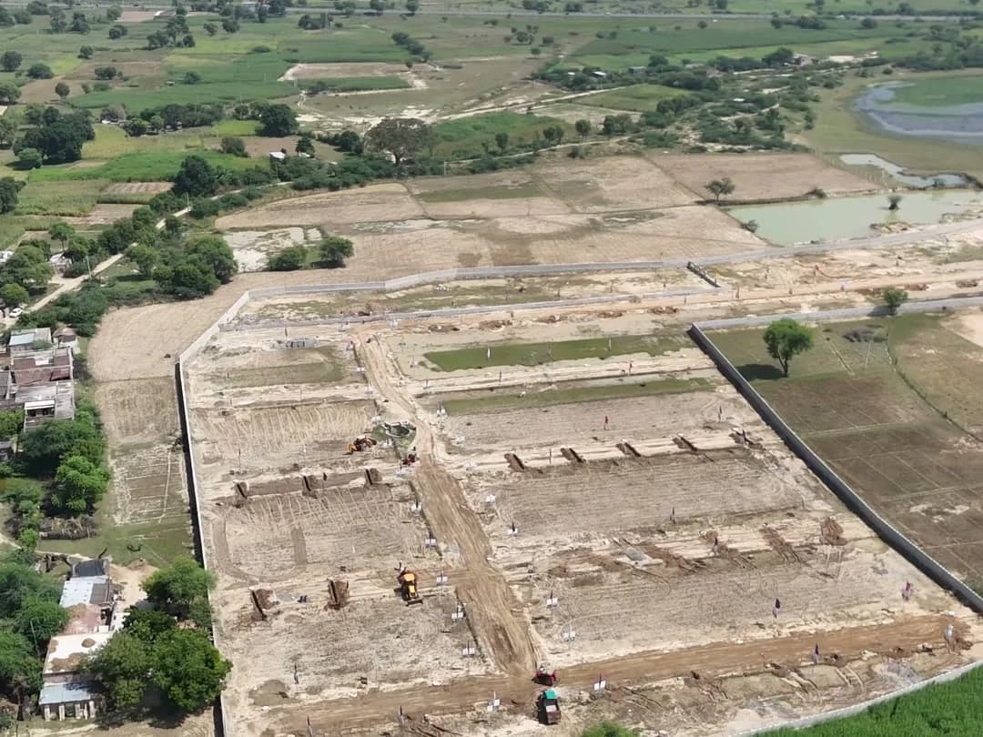 Aerial view of Swarn Nagri Vistar's plotted layout and boundary wall near Chaksu