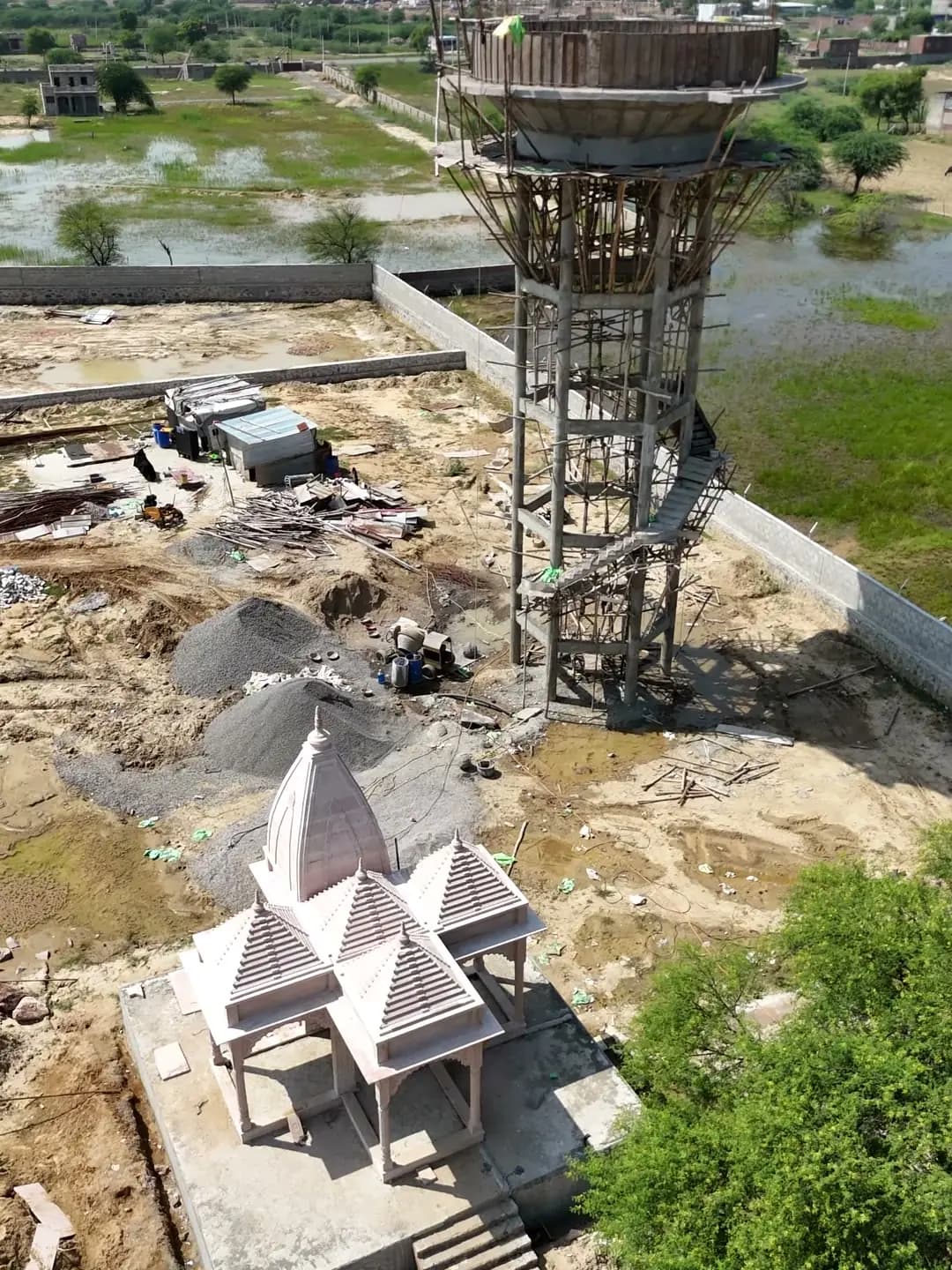 Temple and overhead water tank under construction at Swarn Nagri Vistar