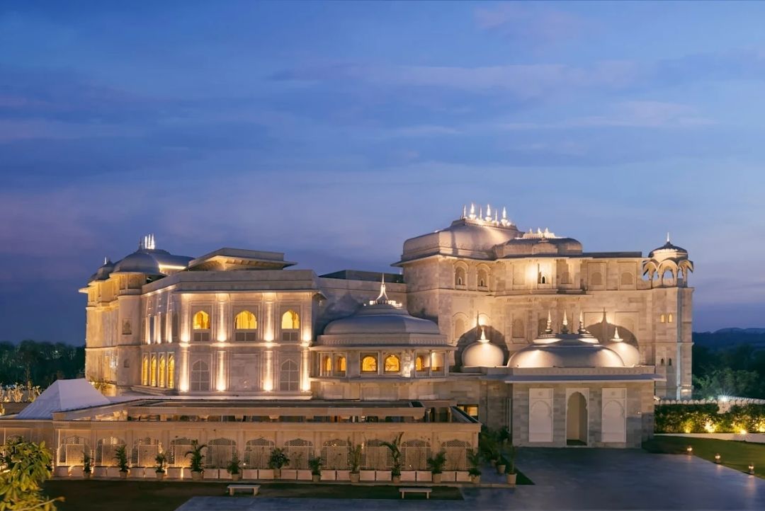 Raffles Jaipur illuminated marble palace facade at dusk