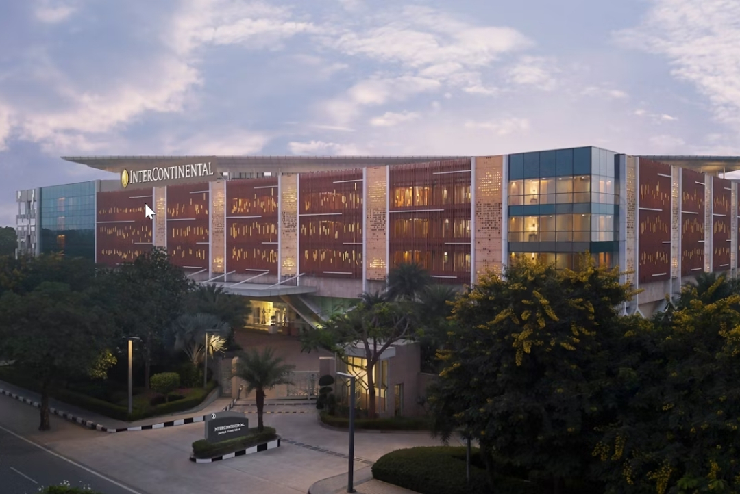 InterContinental Jaipur Tonk Road — illuminated hotel facade and entrance at dusk