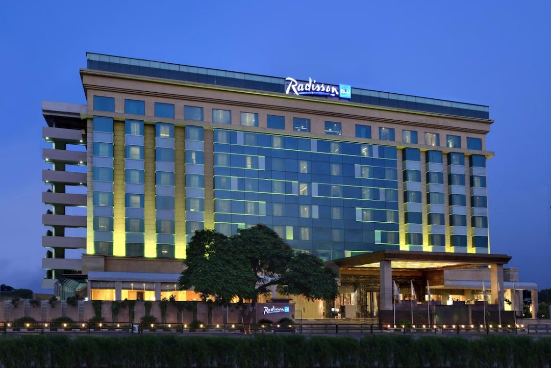 Radisson Blu Jaipur — illuminated hotel exterior at dusk