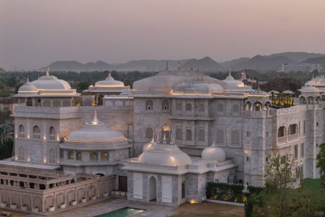 Raffles Jaipur palace exterior and pool at dusk