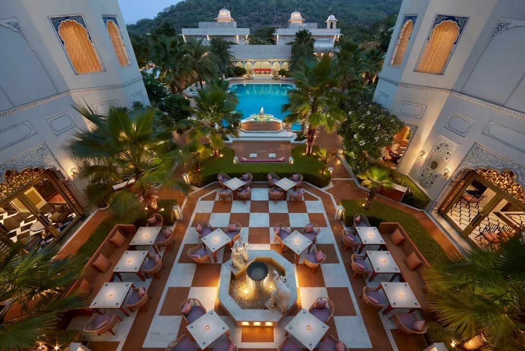 Courtyard dining and pool at The Leela Palace Jaipur