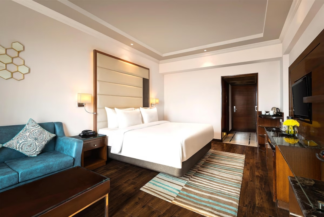 Room with lounge seating — Radisson Jaipur City Center
