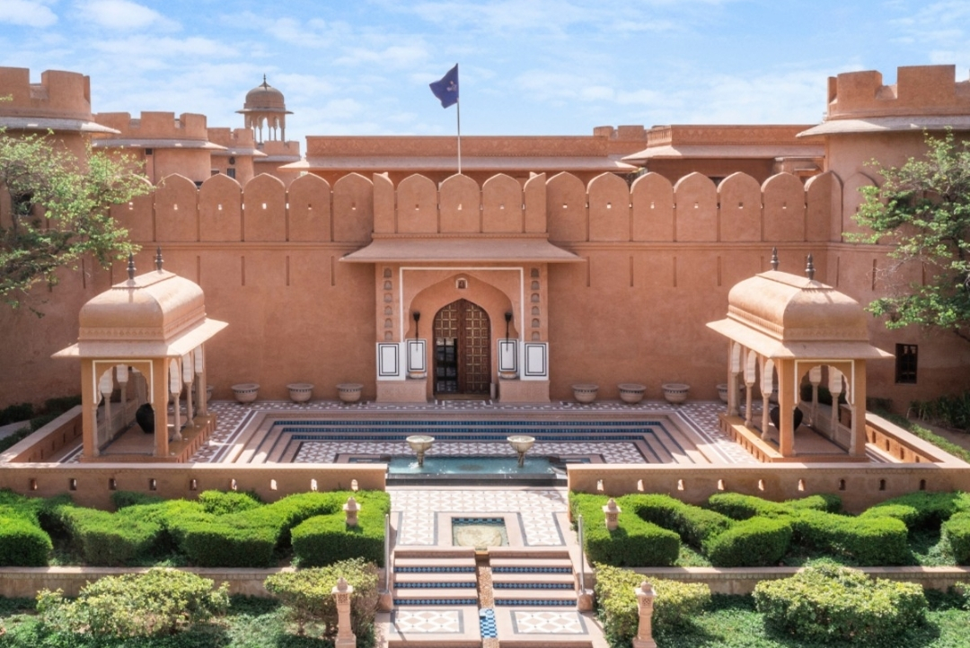 The Oberoi Rajvilas, Jaipur — main building facade and formal Mughal garden