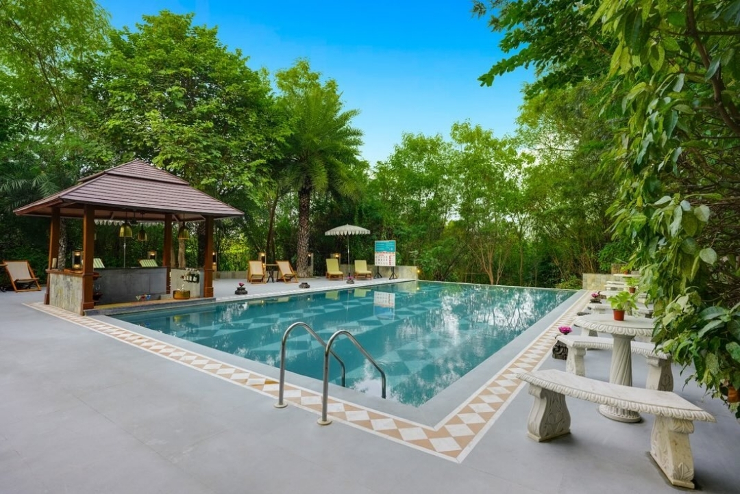Poolside gazebo and loungers — The Tree House Resort, Jaipur