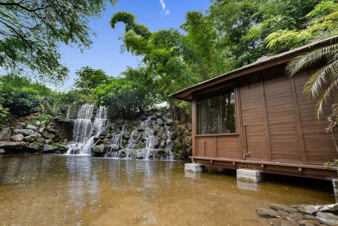 Waterfall beside a cottage — The Tree House Resort, Jaipur
