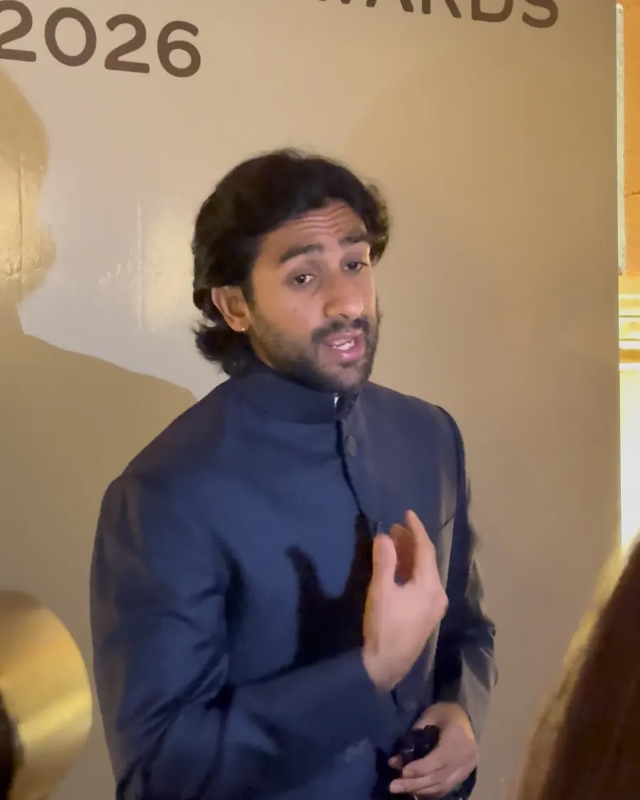 Maharaja Sawai Padmanabh Singh in a navy bandhgala speaking in front of a Sawai Jaipur Awards 2026 backdrop