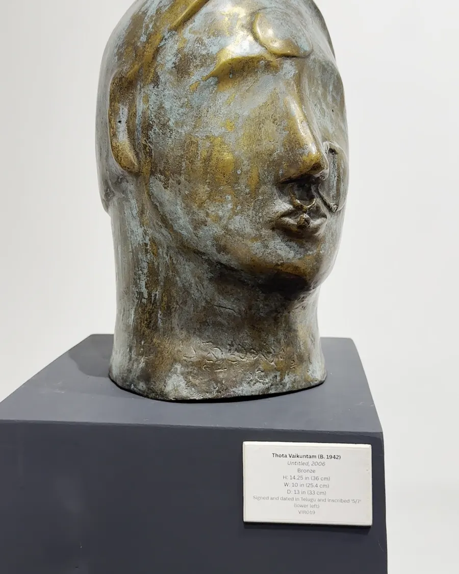 A bronze sculpted head on a plinth at the Virtuosity exhibition