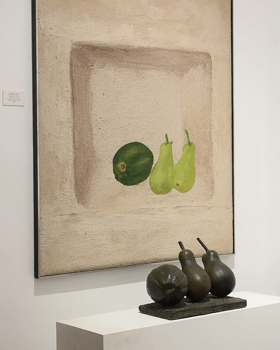 A still life of fruit above a bronze sculpture of pears at ICA Gallery